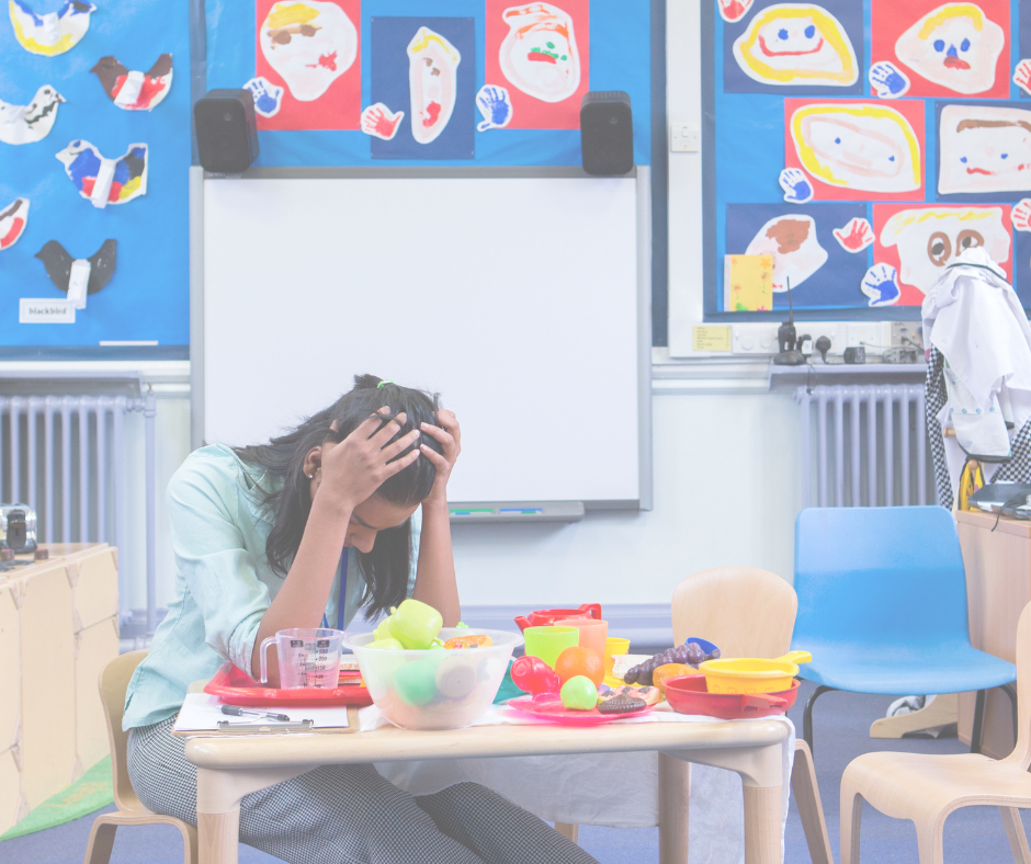 Stressed teacher with head in hands